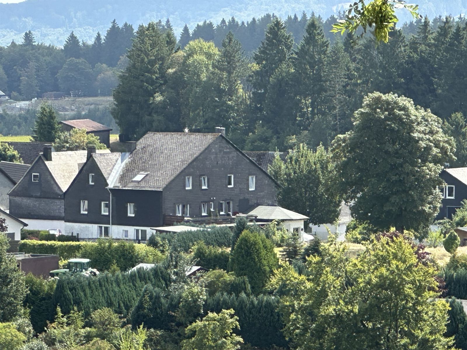 View over the village and the green meadows and hills in summer